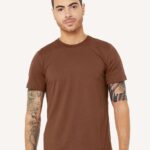 Man with tattoos wearing a chestnut colored Bella + Canvas jersey unisex short sleeved t-shirt