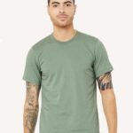 Man with tattoos wearing a sage colored Bella + Canvas jersey unisex short sleeved t-shirt