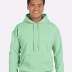 Gildan Custom Dryblend Hooded Sweatshirt in mint green, made from moisture-wicking cotton-poly blend. Features a double-lined hood with drawcord, front kangaroo pocket, and ribbed cuffs and waistband. Shown blank and ready for custom logo or design printing.