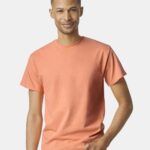 Man wearing Gildan Heavy Cotton t-shirt in tangerine color