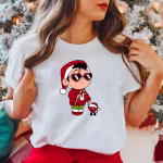 Woman wearing a white Baby Benito Christmas T-Shirt in front of a Christmas tree, showing off the festive design.
