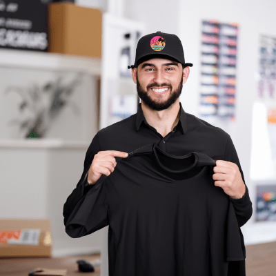 A Hollywood Prints team member holding one of our shirts showing off the high quality services we offer
