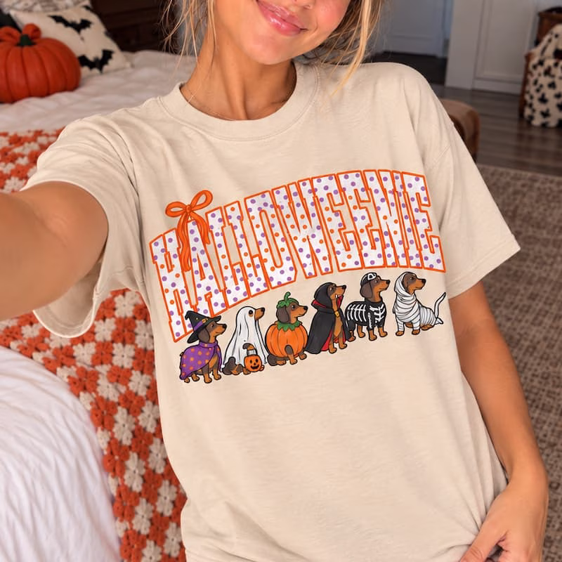 Halloweenie sweatshirt with six dachshunds dressed in Halloween costumes