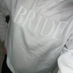 Custom Bride Embossed Puff Print Sweatshirt in white being worn by a beautiful bride.