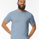Man with beard wearing a stone blue Gildan softstyle short sleeve t-shirt.