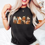 A woman wearing a black shirt that shows an assortment of halloween themes coffees