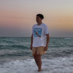 Tropical Sips Slick Brand shirt on model walking on sand at South Beach
