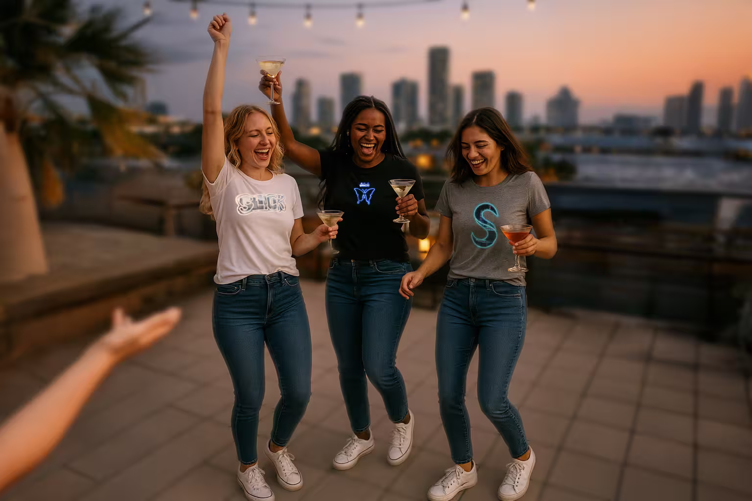 Women partying in Slick Brand t shirts from The S Collection at a Miami rooftop bar