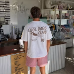 Man wearing cool dads club shirt in navy white variant