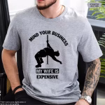 Man wearing a Funny Husband Shirt in gray color variant that says Mind Your Business My Wife Is Expensive.