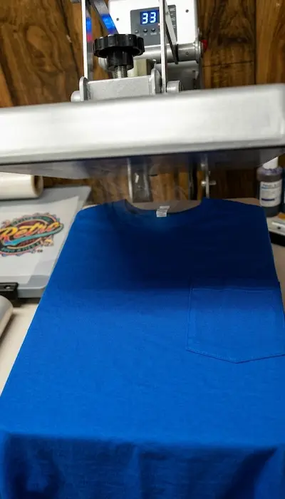Cotton shirt being pre pressed before applying a custom DTF transfer