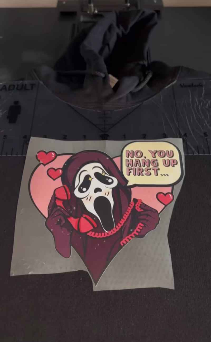 Photo DTF transfer positioned on T-shirt before heat pressing
